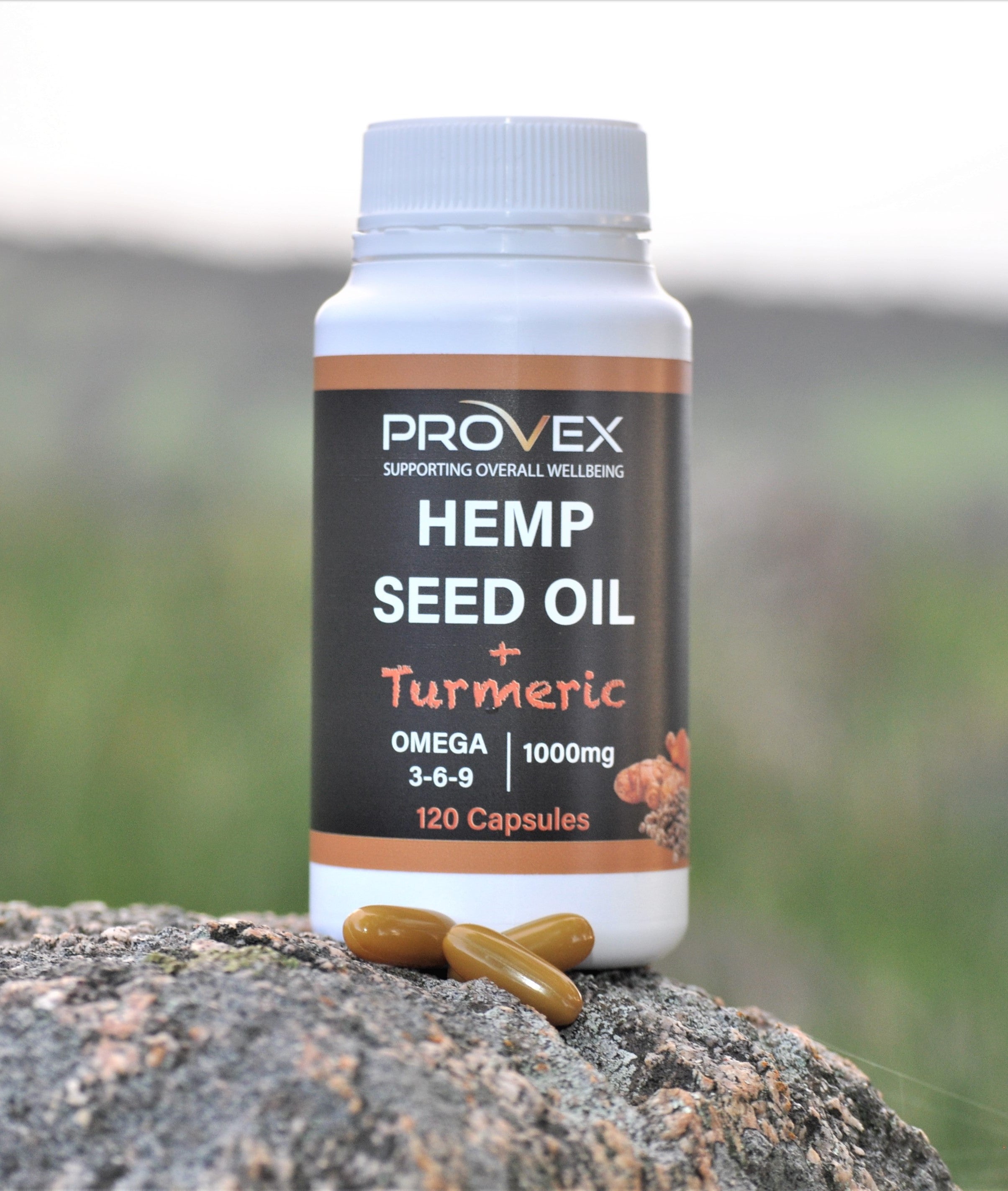 Provex Australian Hemp Seed Oil and Turmeric Capsules 120 Softgels with individual capsules opened and placed on natural rock surface